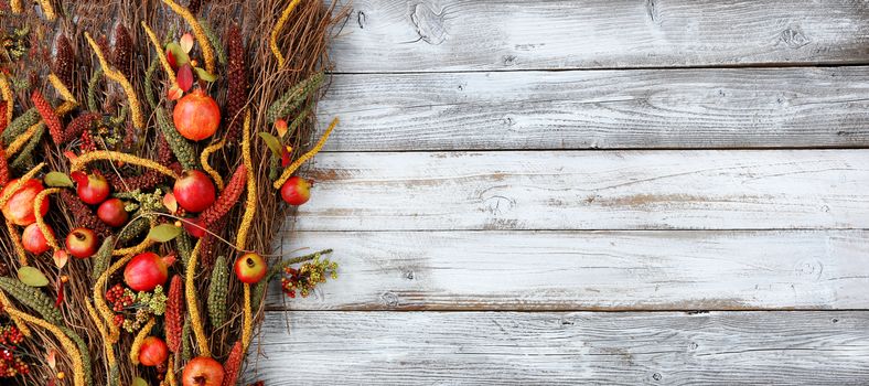 Thanksgiving decorations on left side of white rustic wood 