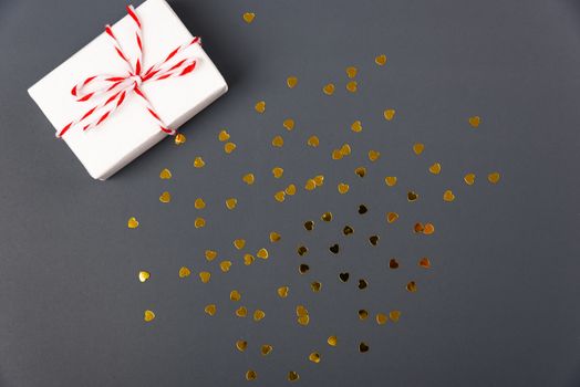 Valentine's day Concept, flat lay top view, White Gift Box and Red Heart on Gray background with copy space for your text