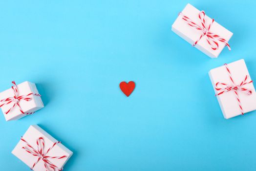 Valentine's day Concept, flat lay top view, White Gift Box and Red Heart on Blue background with copy space for your text