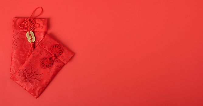Chinese new year festival concept, flat lay top view, Happy Chinese new year with Red envelope (Character "FU" means fortune, blessing, wealth) on red background with copy space for your text