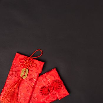 Chinese new year festival concept, flat lay top view, Happy Chinese new year with Red envelope (Character "FU" means fortune, blessing, wealth) on black background with copy space for your text