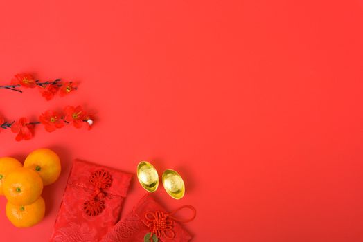 Chinese new year festival concept, flat lay top view, Happy Chinese new year with Red envelope and gold ingot (Character "FU" means fortune, blessing) on red background with copy space for text