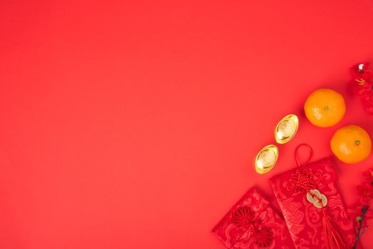 Chinese new year festival concept, flat lay top view, Happy Chinese new year with Red envelope and gold ingot (Character "FU" means fortune, blessing) on red background with copy space for text