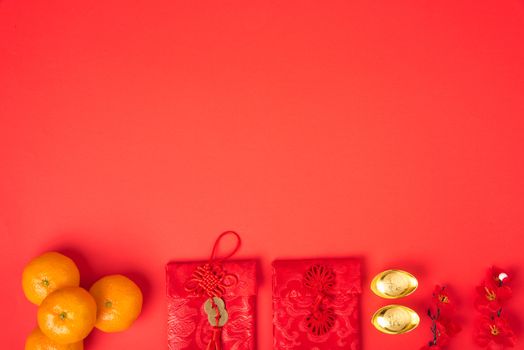 Chinese new year festival concept, flat lay top view, Happy Chinese new year with Red envelope and gold ingot (Character "FU" means fortune, blessing) on red background with copy space for text