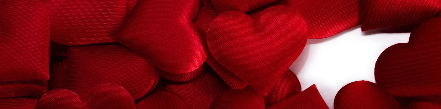 Valentine's day many red silk hearts background and white copy space, love concept