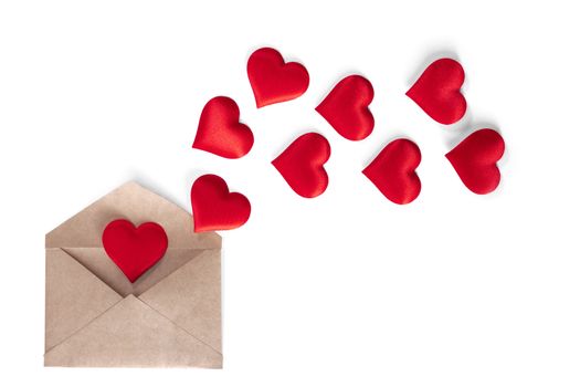 Valentine day love letter, envelope of white paper with red hearts heap spread on white background.