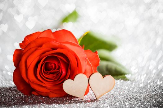 Rose and hearts on silver glowing bokeh hearts background for Valentines day