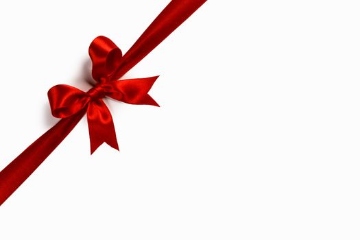 Red satin ribbon bow isolated on white background