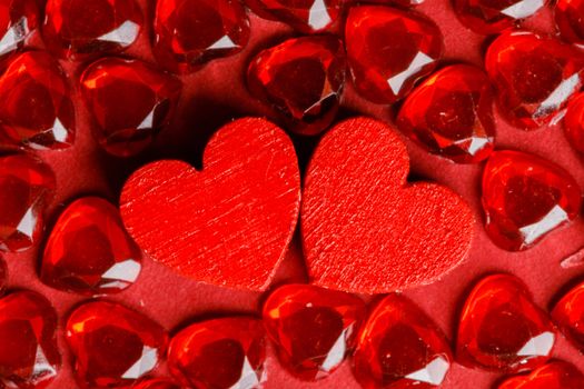 Two wooden hearts between gems background, two red special ones true love concept