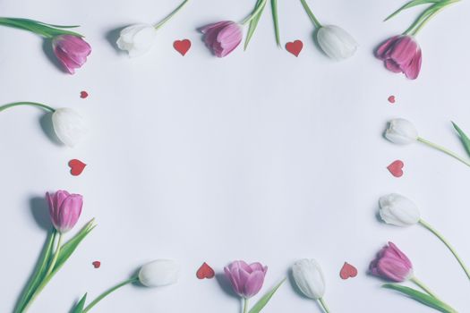 Frame made of colourful tulips and red hearts Valentines day background