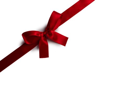Red satin ribbon bow isolated on white background
