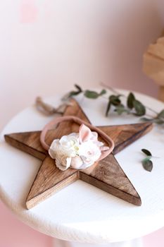 Beautiful fashion accessory for baby girls. Handmade accessories lace and stars on elastic band on white and brown background. Concept of children's clothing