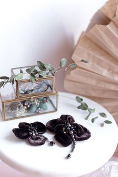 Beautiful fashion accessory. Handmade accessories brown brooch on white and brown background