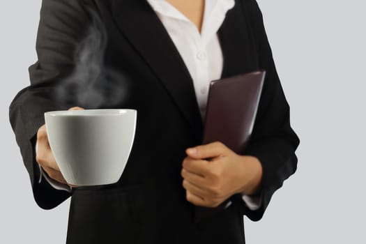 Coffee break, Young businesswoman enjoying in a cup of coffee isolated on gray background, clipping path.