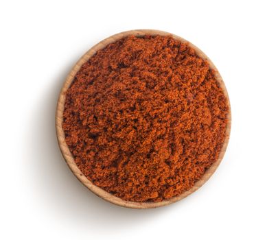 Red paprika powder in bowl isolated on white background, top view
