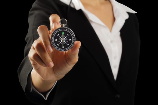 Businesswoman hand holding vintage retro compass isolated on black with clipping path, Instrument that indicates magnetic north.