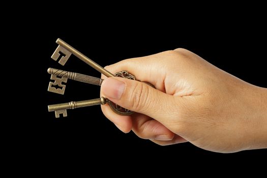 Woman hand holding triple key isolated on black background, clipping path.    