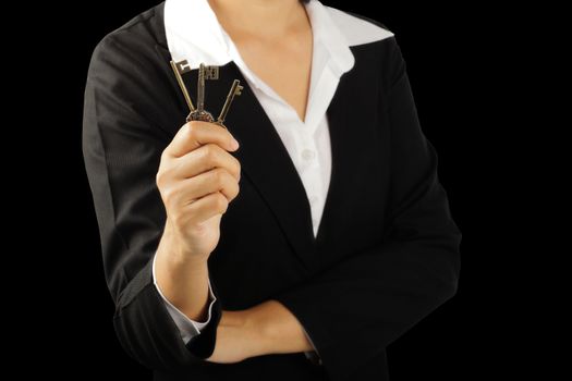 Businesswoman hand holding triple key isolated on black background, clipping path.    