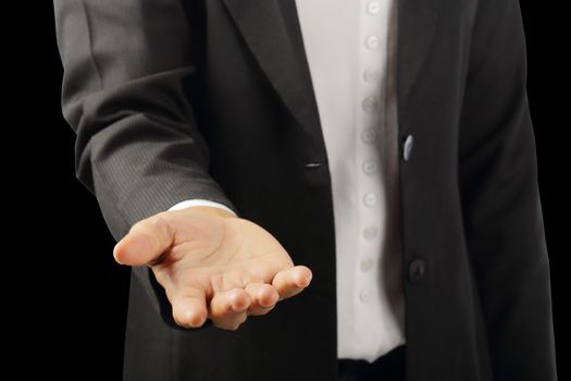 Businessman's hand to showing something isolated on black background with clipping path, concept advertisement product.