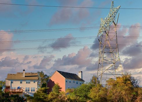 High power electrical tower and lines over expensive houses