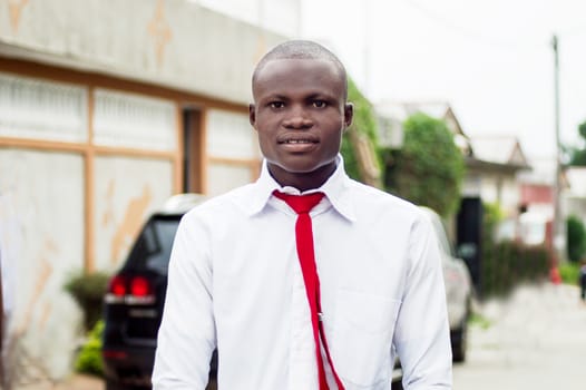 Portrait of smiling young man standing in the street.