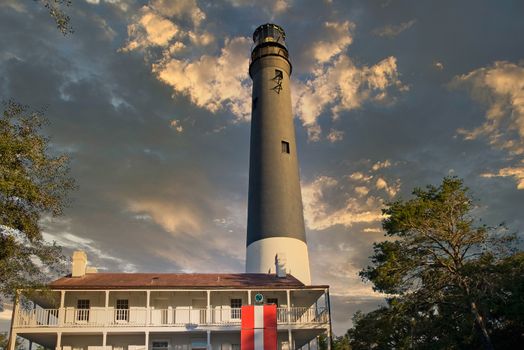 Black and white lighthouse at Pensacola behind house