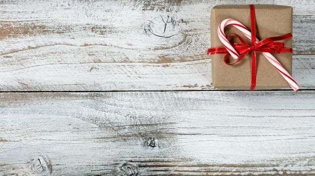 Christmas gift on weathered white wooden background