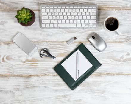 Overhead view of a modern technology devices on white wooden desktop 