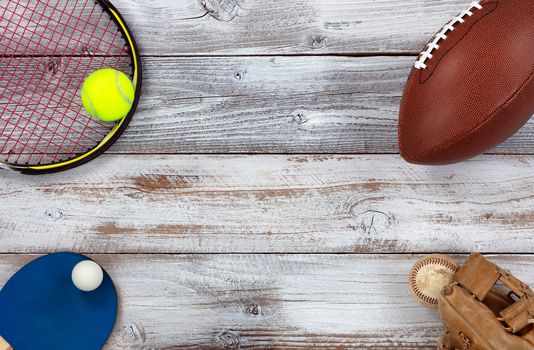 sports equipment located at corners of white rustic wood 