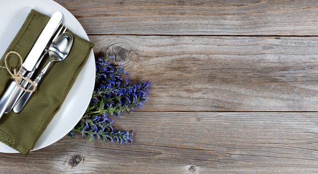 Vintage table setting with fresh flowers on rustic wood