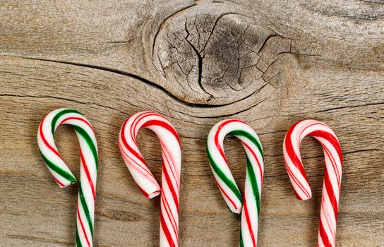 Candy canes on rustic wooden board. Layout in horizontal format. 
