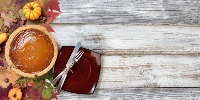 Freshly baked homemade pumpkin pie and serving plate for Thanksgiving dessert