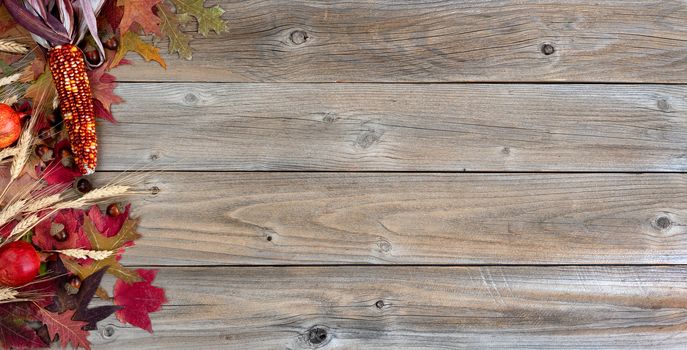 Autumn decorations consisting of leaves, corn, acorns and weathered wood