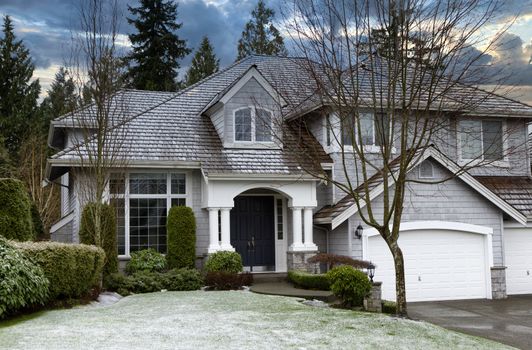 Home and front yard with early seasonal snow storm 