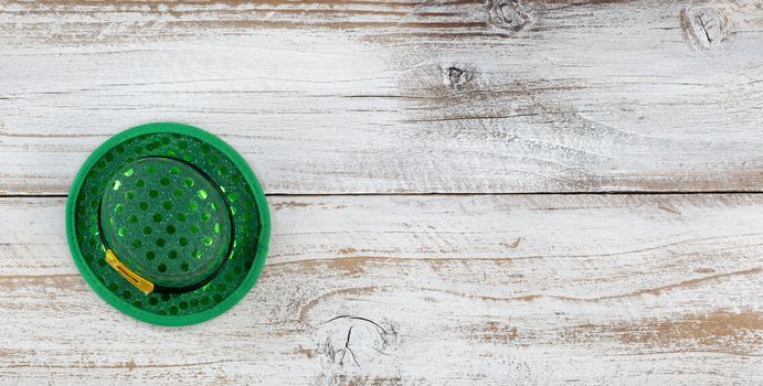 St Patricks day good luck hat on weathered white wood in overhead view