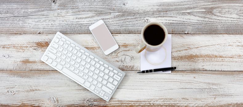 Top view of functional desktop with various office equipment and dark coffee 