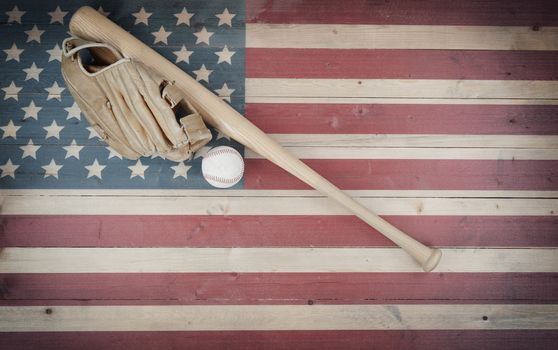 Old American baseball equipment on vintage United States wooden flag