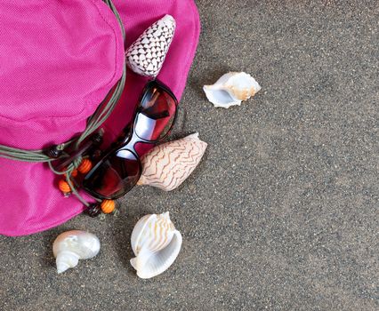 Beach sand hat, sunglasses and seashells 