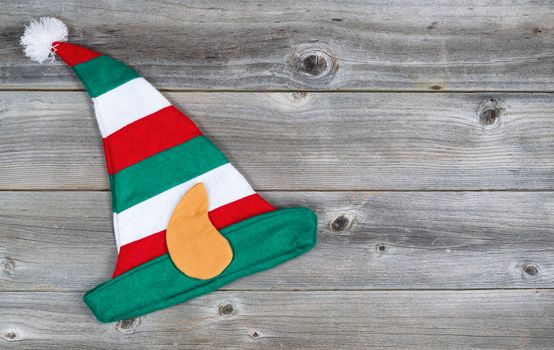 Horizontal image of Christmas elf stocking hat on rustic wooden boards