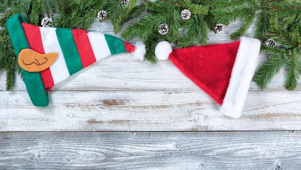 Christmas traditional hat decorations on rustic wood in flat lay format