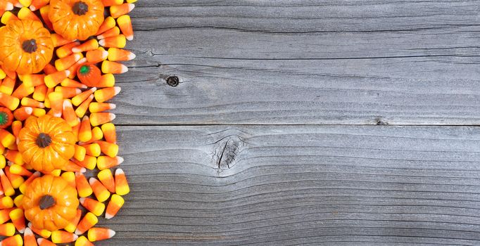 Halloween treats forming left border on weathered wood 