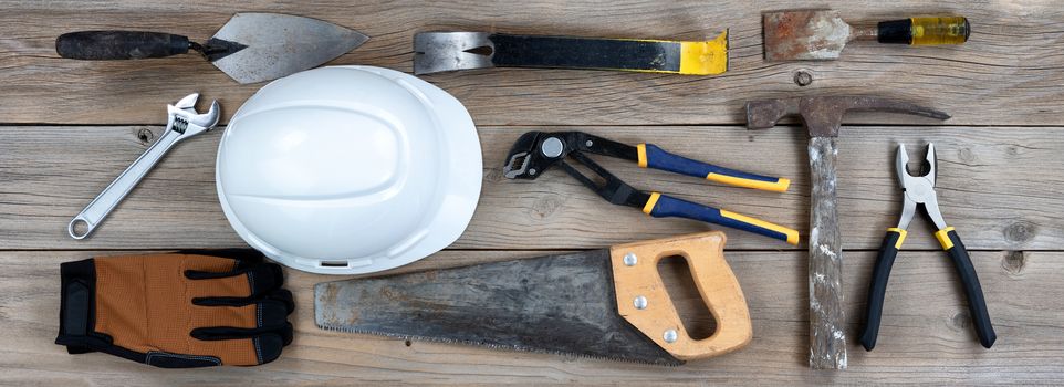 Labor Day holiday background with rustic wood and various worker tools