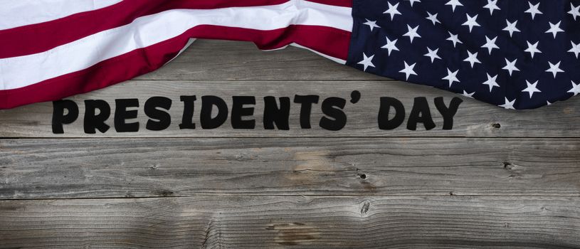 Presidents day in large text letters on rustic wooden boards with US flag in top border 