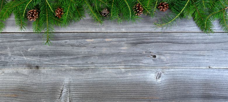 Overhead view of real fir Christmas tree branches on weathered wood  