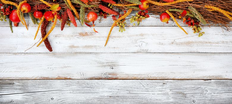 Thanksgiving decorations on top portion of white rustic wood 