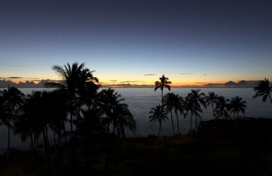 Tropical ocean with fading sunset and stars during late evening 