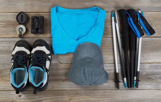 Basic gear, mostly blue color coordination, for outdoor walking on rustic wooden boards. 