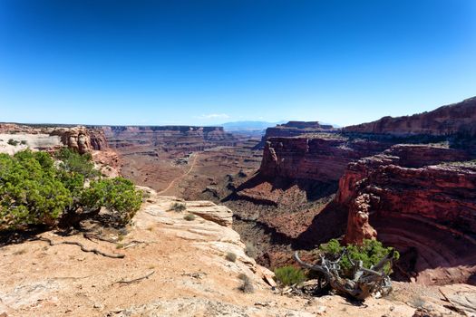 Grand Canyon with ground trail at bottom of valley 