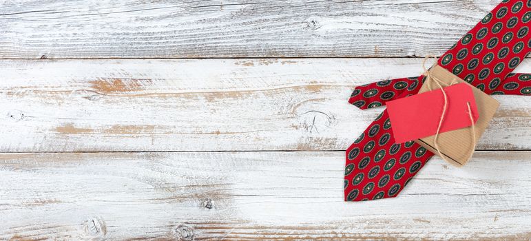 Dotted necktie with boxed gift on white rustic wood for Father’s Day background