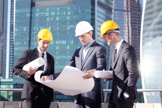 Engineering and architecture concept, engineers working on a building site holding blueprints , architects and engineers inspection in workplace for architectural plan